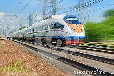 Diagonal view on high speed train runs on rail way tracks with motion blur effect background. Russian railways electric high speed Editorial Stock Photo