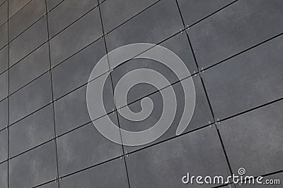 Diagonal view of smooth gray rectangular tile on wall, for background or design Stock Photo