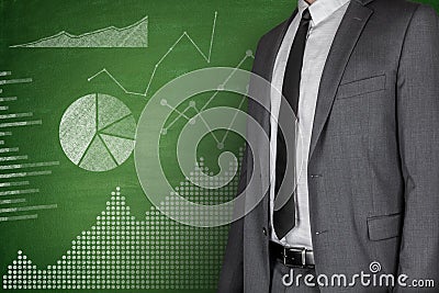 Diagrams and Businessman on Blackboard Stock Photo