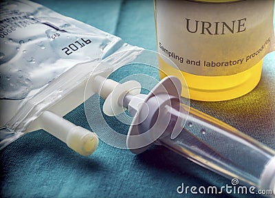 Dial flow next to a urine sample at a hospital table Stock Photo