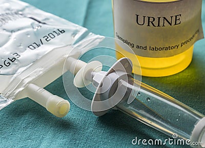 Dial flow next to a urine sample at a hospital table Stock Photo