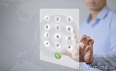 Dialing on virtual telephone keypad with transparent telephone buttons, businessman touch button of telephone number on screen, Fi Stock Photo