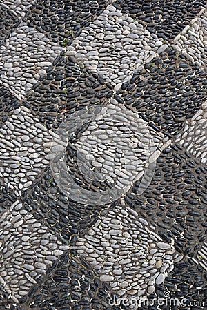 A diamond patterned pavement made from dark and light coloured pebbles Stock Photo