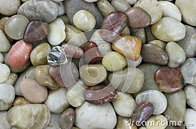 Diamond in the Rough; Natural colored small smooth stone background Stock Photo