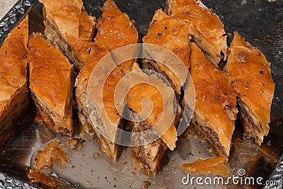 Diamond shape homemade Turkish baklava. Baklava in a metal tray. Baklava with walnut. Cevizli baklava in Turkish Stock Photo