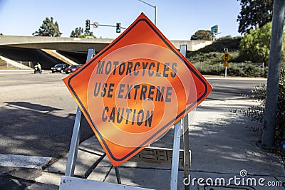 A diamond shaped road sign advising motorcycle riders to use extreme caution Stock Photo