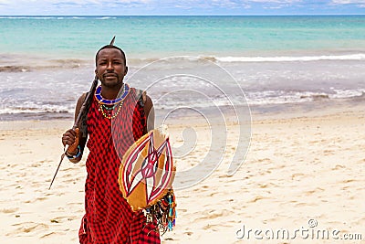 Diani Beach, Ukunda, Kenya - August, 2019: African Maasai warrior with spear and shield at the Diani beach Editorial Stock Photo