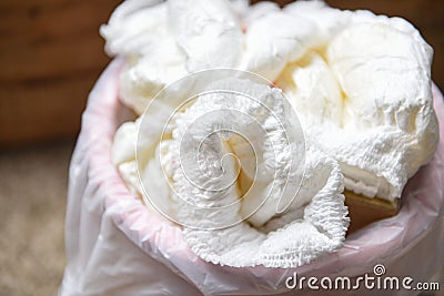 Diapers waste - dirty diapers in a garbage pail Disposing of used baby nappies Stock Photo