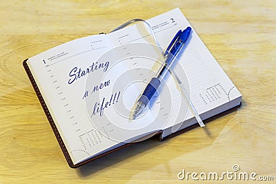 The diary with the entry is open on the page of the first of January. Stock Photo