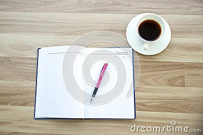 Diary and notebook for Planner to plan agenda, reminder, timetable, daily appointment, management on table. Calender, and cup of Stock Photo