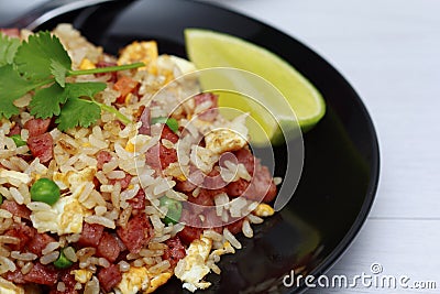 Dice Bacon Fried rice in black dish Stock Photo