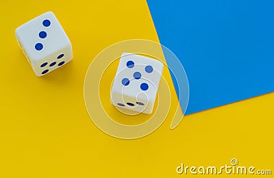 Dice with blue dots on a yellow background Stock Photo