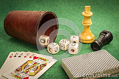 Dice Cup with Deck Cards and Chess Pieces Stock Photo