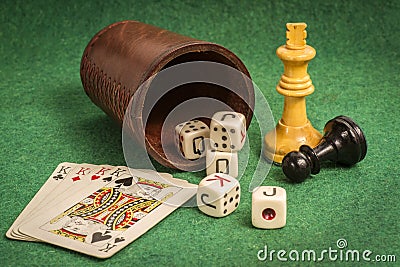 Dice Cup with Deck Cards and Chess Pieces Stock Photo