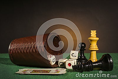 Dice Cup with Deck Cards and Chess Pieces Stock Photo