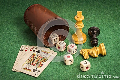 Dice Cup with Deck Cards and Chess Pieces Stock Photo