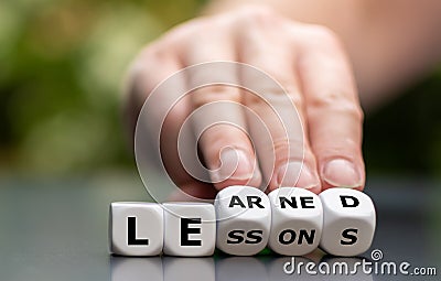 Dice form the expression lessons learned. Stock Photo