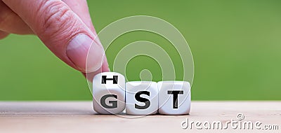 Dice form the expressions `GST` Goods and Services Tax and `HST` Harmonized Sales Tax. Stock Photo