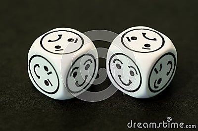 Dice with happy emoticon sides facing each other Stock Photo