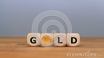Dice and a Krugerrand coin form the word `GOLD` Stock Photo