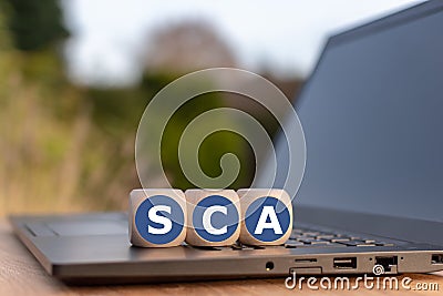 Dice placed on a notebook for with the abbreviation `SCA` Stock Photo