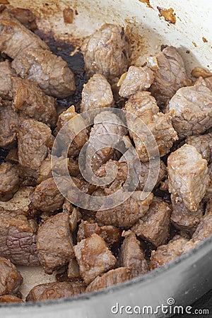 Diced beef with onions, Aberdeen Angus beef, cooking in a casserole dish Stock Photo