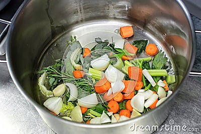 Diced fresh vegetables and herbs in a saucepan Stock Photo