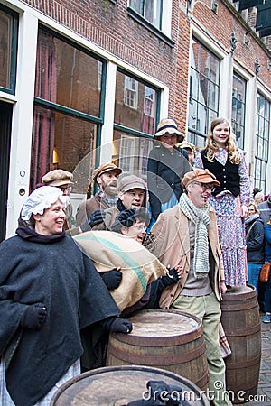 Dickens festival Christmas carol people sing at old wine barrels Editorial Stock Photo