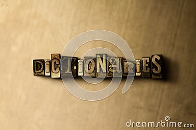DICTIONARIES - close-up of grungy vintage typeset word on metal backdrop Cartoon Illustration