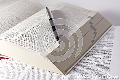 Dictionary with a pen Stock Photo