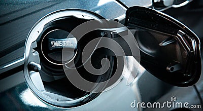 Diesel car concept. Open car fuel tank cap with the word diesel. Stock Photo