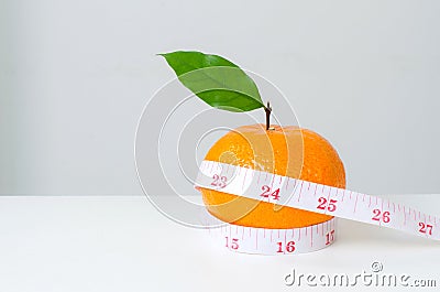 Diet concep, Orange fruit and measuring tape Stock Photo