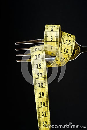 Diet concept. Metallic fork Stock Photo