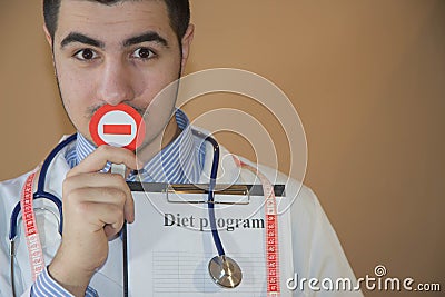 Diet creativity concept. Young Male nutritionist standing in her office. Doctor in dieting concept Stock Photo