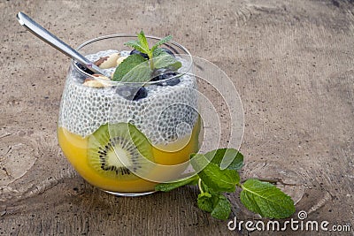 Diet dessert in the form of fresh fruit salad with kiwi and peach with chia seed Stock Photo
