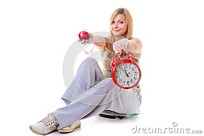 Woman holding apple, measuring tape and clock Stock Photo