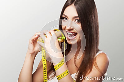 Diet. Harmful and useful food. A young girl makes a choice either for a diet or for a meal. Sport. The concept of health and beau Stock Photo