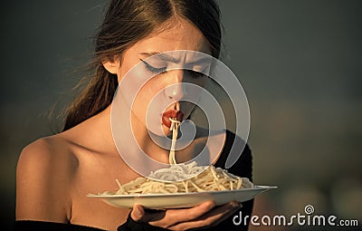 Diet and healthy organic food, italy. Chef woman with red lips eat pasta. Hunger, appetite, recipe. Woman eating pasta Stock Photo