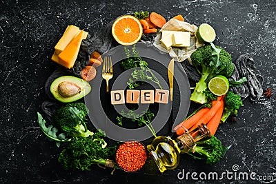 `DIET` inscription: Avocado, carrot, orange, broccoli, dried fruits, nuts and parsley. Stock Photo