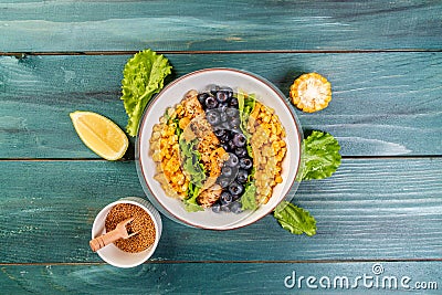 Diet menu. Healthy Green salad with chicken breast, corn, lemon, mustard and blueberries. Top view Stock Photo