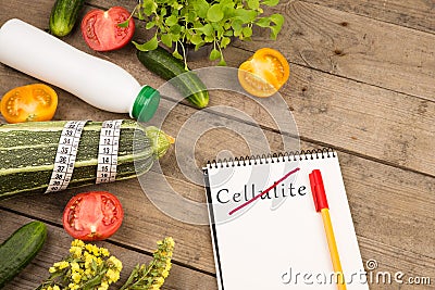 Diet plan - marrow squash, notepad with text & x22;No Cellulite& x22;, vegetables and measuring tape Stock Photo