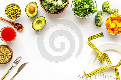 Diet program concept. Empty plate, measure tape and vegetables on white background top view copy space Stock Photo