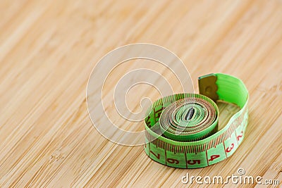 Diet. Restriction in nutrition. Measuring tape on the table with space for text. Slimming. Weight loss concept, weight management Stock Photo