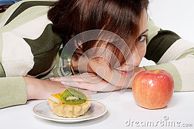 Diet temptation - cake against apple Stock Photo