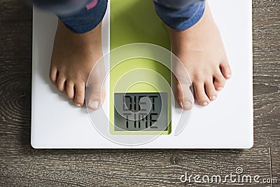 Diet time message on weight scale, overweight child concept Stock Photo