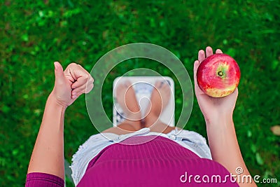Diet and weight concept. Young woman standing on a scale with an Stock Photo