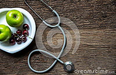 Diet and weight loss with measuring tap and green apple on wooden background top view. Stock Photo