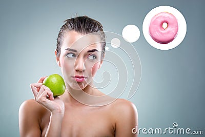 Â The Diet! Woman eating an apple , but he thinks a donut Stock Photo