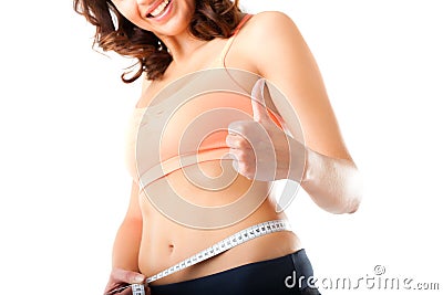 Diet - young woman is measuring her waist Stock Photo