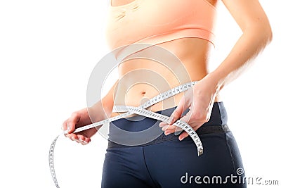 Diet - young woman is measuring her waist Stock Photo